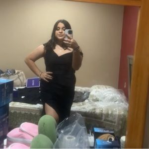 Long black dress with a slit on the side of the shoulder.